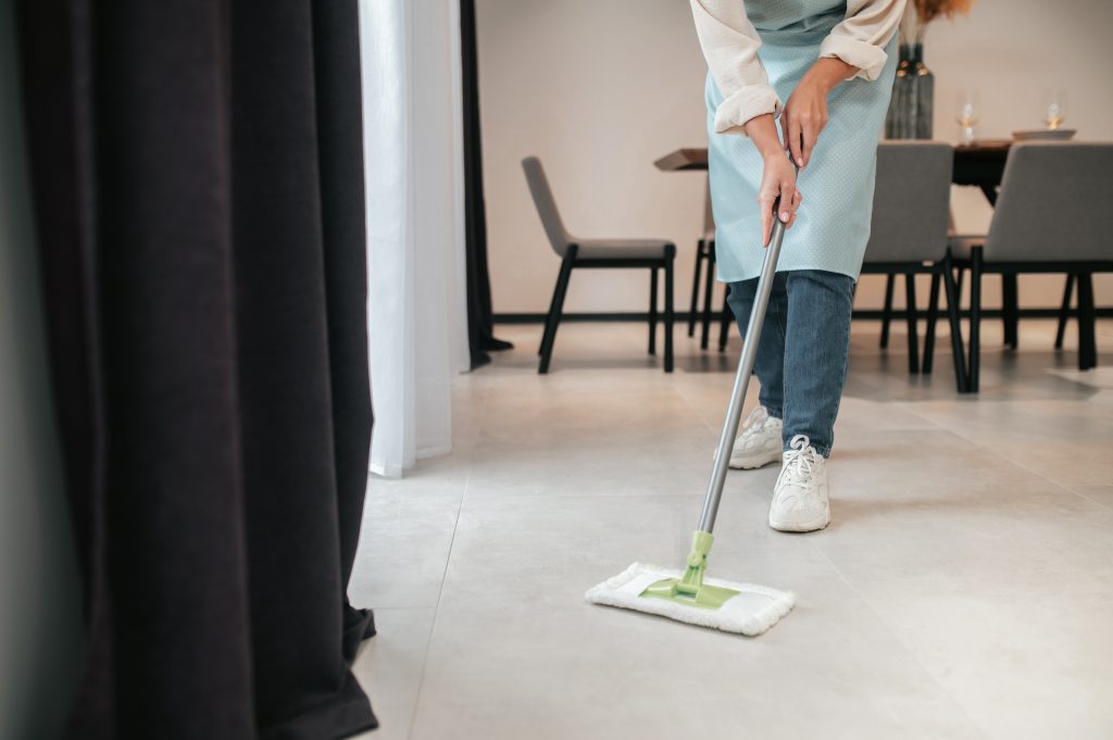 cleaning kitchen young woman apron cleaning floor kitchen
