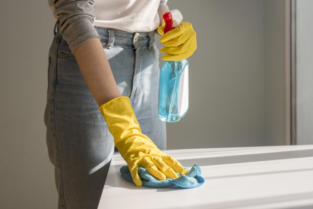 front view woman cleaning surface