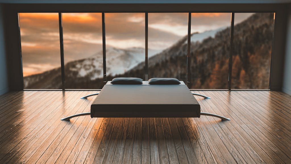 6 Teknologi Smart Home yang Mengubah Interior Rumah Mewah Jadi Masa Depan 7 Minimalist bedroom with large windows offering a breathtaking mountain view during sunset.