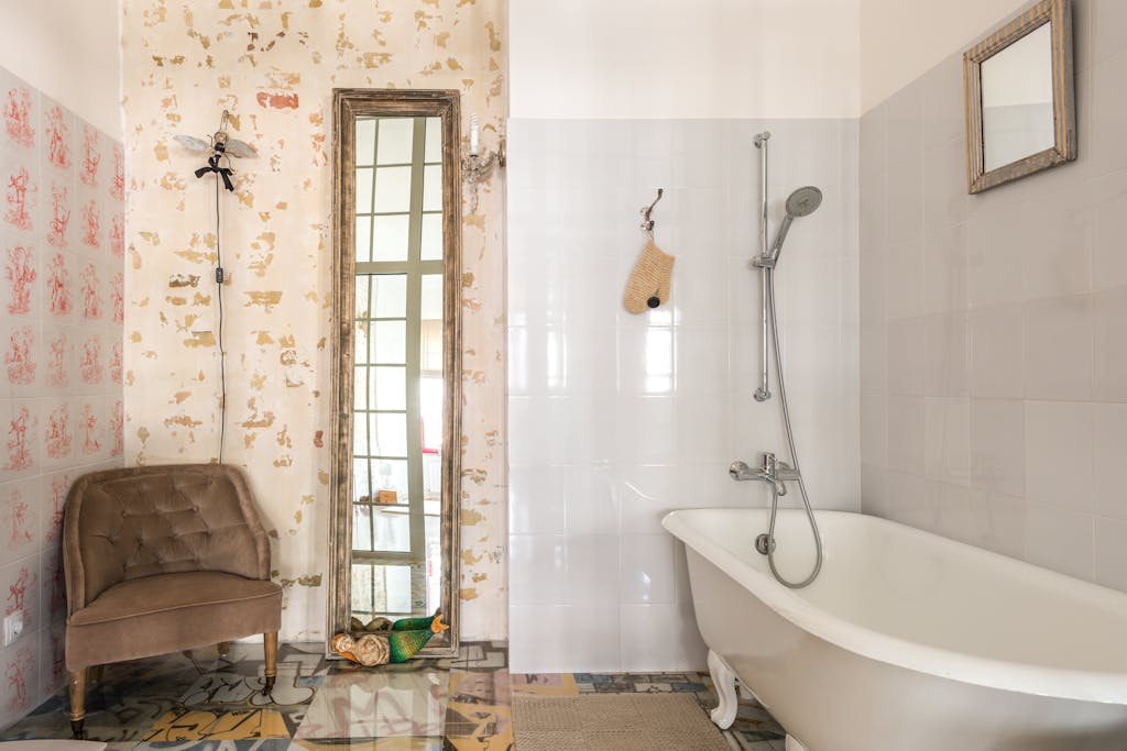 Charming bathroom with vintage armchair and elegant bathtub.