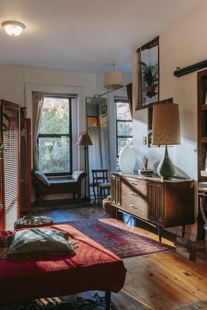 Mau Memilih Karpet? Ini 5 Hal Ini Wajib Kamu Tahu Agar Tidak Menyesal 5 Interior of stylish vintage styled room with comfortable bed and classic wooden cabinet decorated with lamps and plants in sunlight