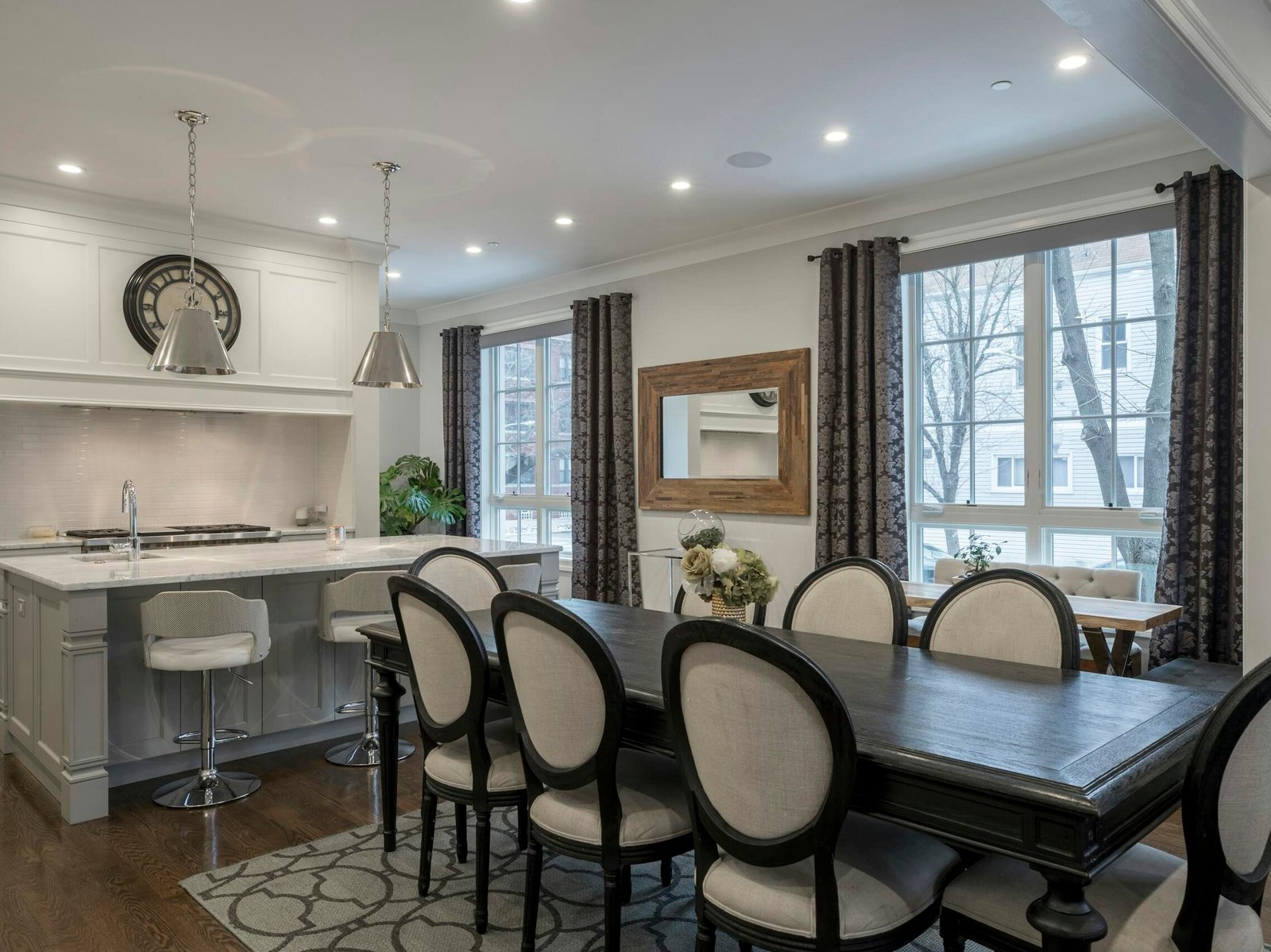 5 Furnitur Esensial untuk Rumah Baru 3 Stylish and contemporary kitchen and dining area with chic furniture and natural lighting.